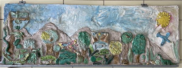 A ceramic and cement wall sculpture created by sixth-graders